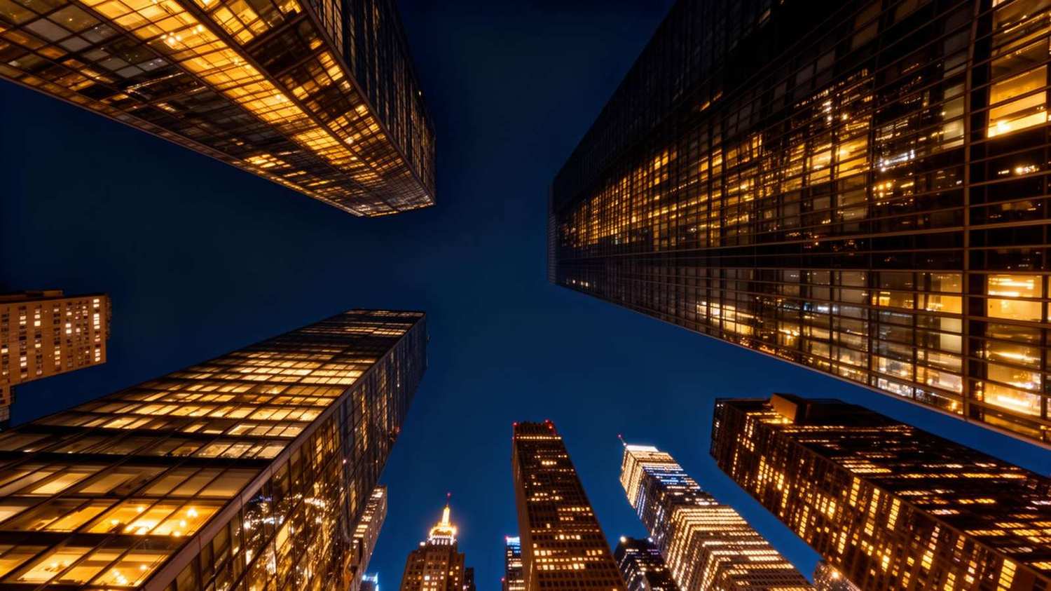 New York City skyline at night with illuminated skyscrapers and the East River